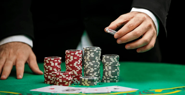 A man holding Casino Chips during a card game