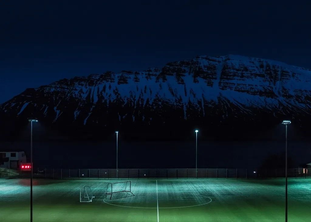 Floodlit football pitch at night