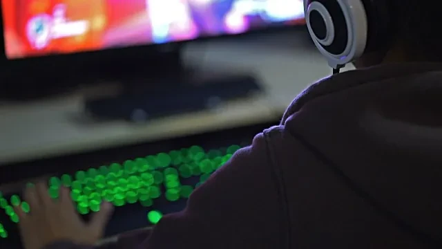 Gamer with headset at a PC