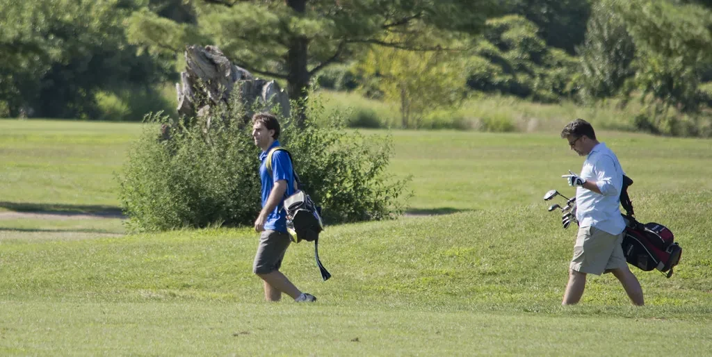 Golfers walking with their bags