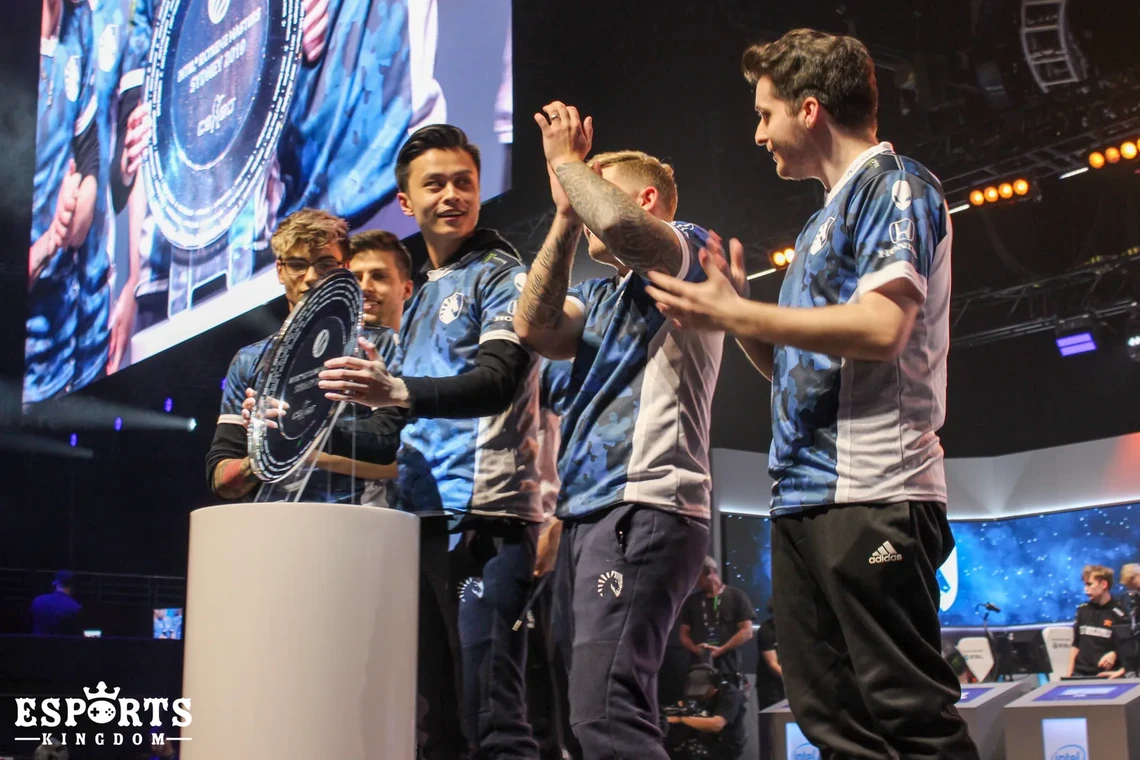 Team Liquid players lifting the trophy on stage