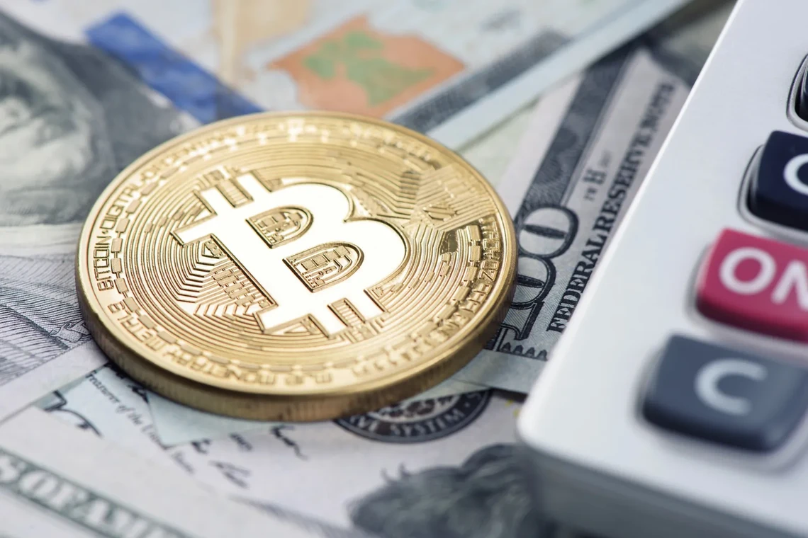 Bitcoin coin on dollar bills