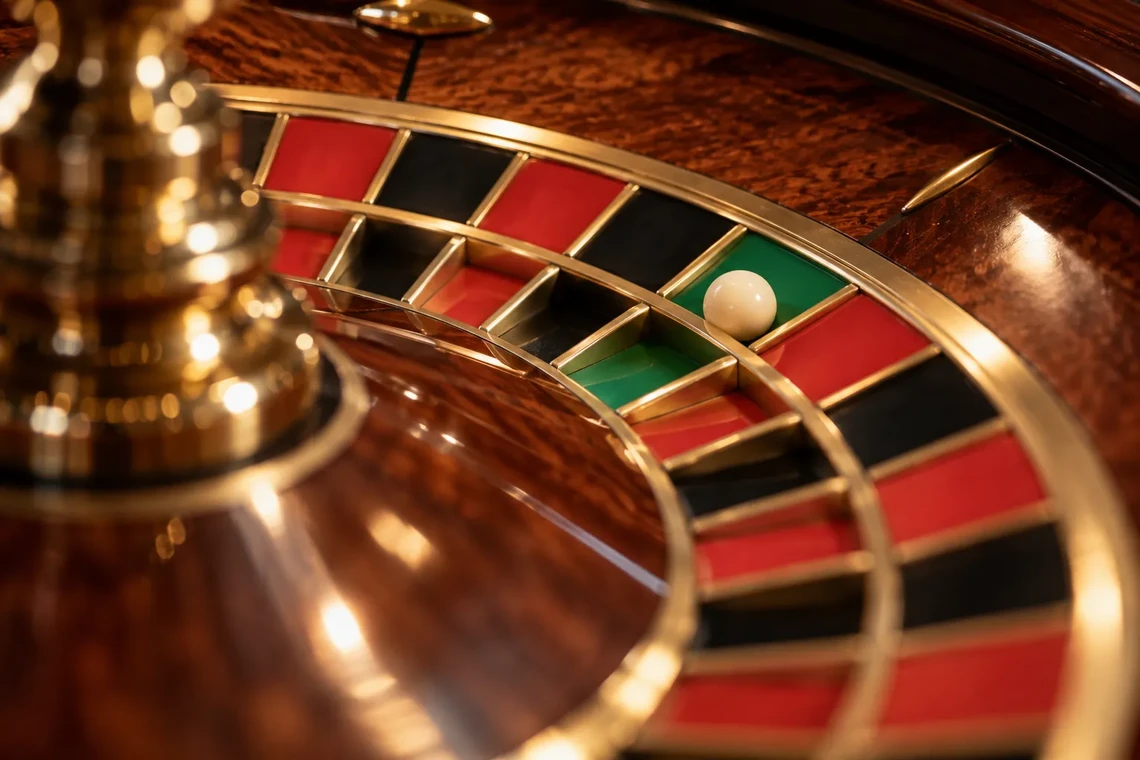 Roulette ball resting in the green zero pocket