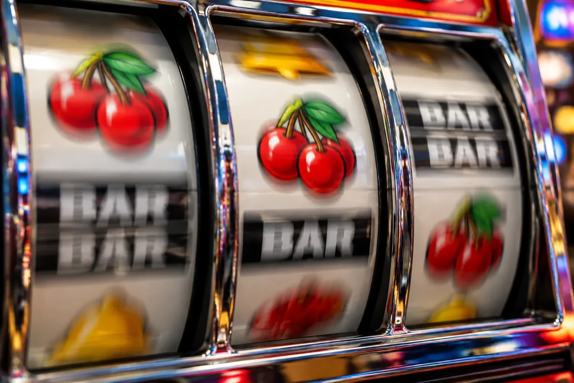 Slot machine reels with a stop button