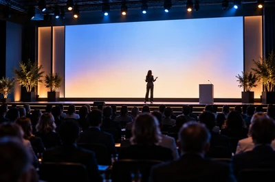 Woman speaking on a conference stage